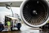 Van with person in hi-vis refueling a jet engine