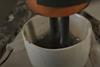 Molten zinc chloride inside a crucible, with two graphite electrodes