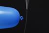 A photo of a charged balloon deflecting a water stream