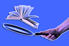 An image showing flipped learning concept, frying pan flipping a textbook