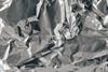 A close-up photograph of wrinkled silver aluminium foil