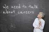 A picture showing a teacher looking at a blackboard with 'We need to talk about careers' written on it
