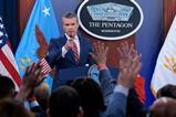 U.S. Secretary of War Pete Hegseth calls on reporters who have their hands raised with questions during a press briefing at the Pentagon