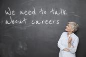 A picture showing a teacher looking at a blackboard with 'We need to talk about careers' written on it