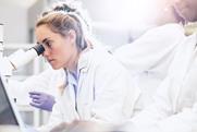 Scientist looking through a microscope