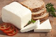 Three slices of tomato, two slices of cheese cut from a block and three slices of bread ready to make a sandwich