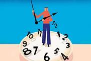 A person stands on the face of a giant disordered clock holding the hands up
