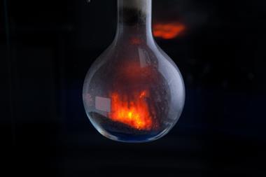 Round bottomed flask containing ammonium dichromate as it decomposes