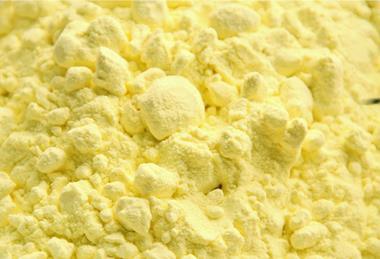 A close-up photograph of yellow sulfur powder