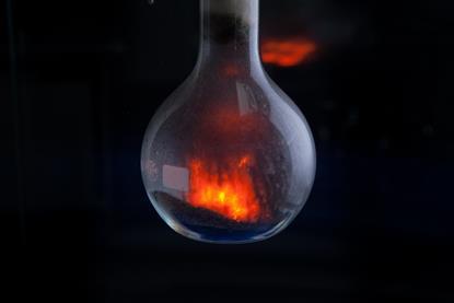 Round bottomed flask containing ammonium dichromate as it decomposes