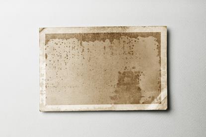 A piece of old photographic paper, creased and discoloured
