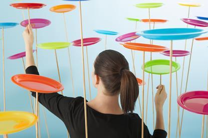 Woman literally trying to keep lots of plates spinning