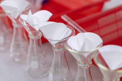 A photograph showing apparatus for filtering mixtures, including conical flasks, glass funnels and filter paper