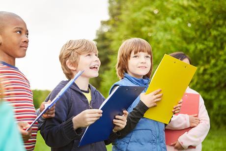 Primary school children with clipboards