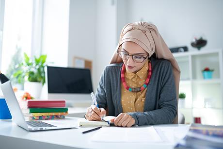 Female primary teachers works at her desk