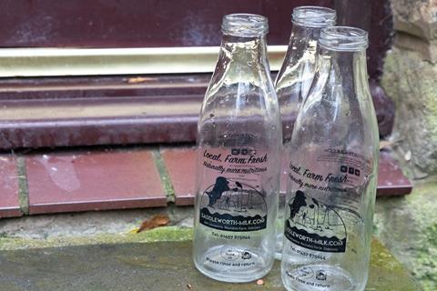 Glass milk bottles on a door step