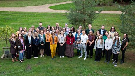 A photograph of the Royal Society of Chemistry's Education team, standing outside in a grassy space and smiling
