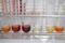 Six test tubes in a metal test tube holder, each containing a red-brown solution at different concentrations