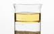 Photo of oil, water and sand separated in a beaker