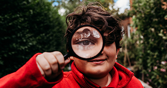 Boy holding magnifying glass