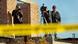 Three journalists with cameras standing on a rooftop in Mexico