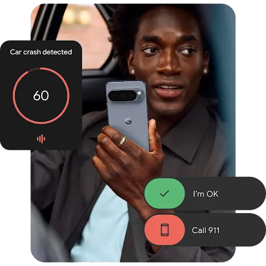 A person sitting in a car is holding their Pixel phone up. An example of Android’s Physical Safety notification is around the border of the image. 