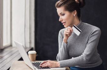 woman on computer with credit card