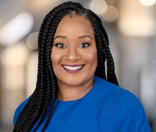 Malika Jeffries-EL smiling to camera in blue top