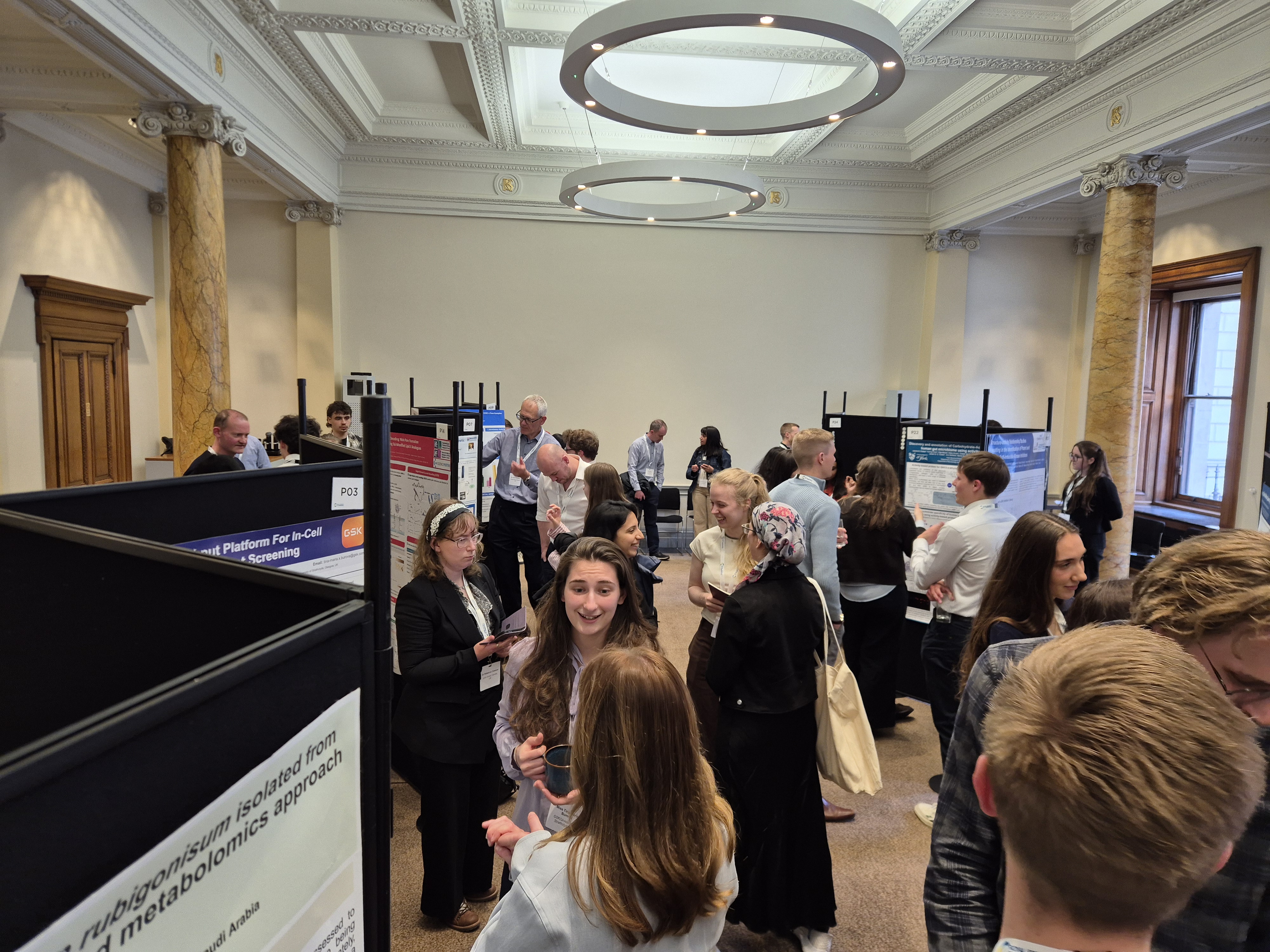 2026 Chemical Biology Symposium - poster session (1) Dozens of delegates mingle around a zig-zag of poster displays