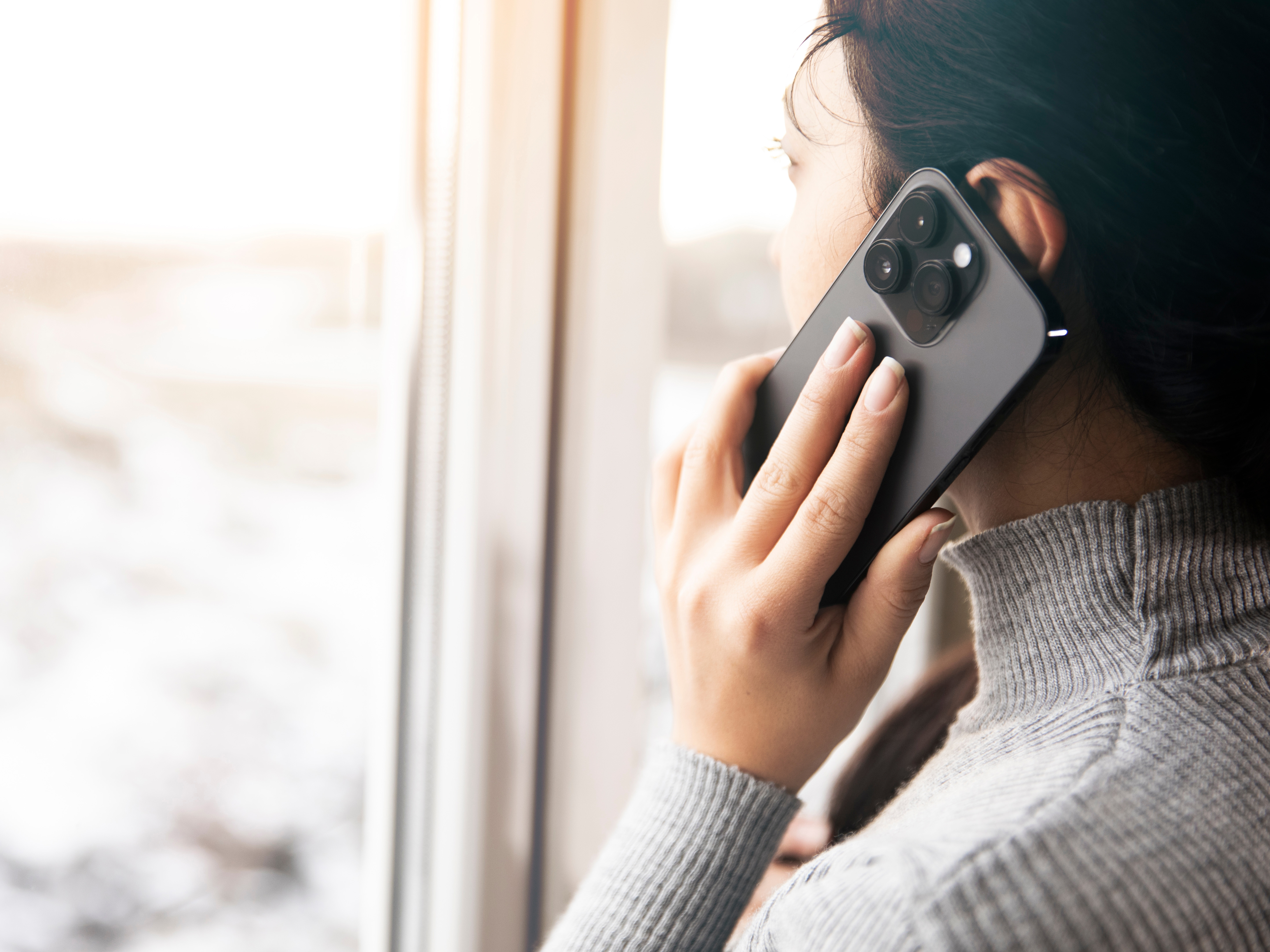 a woman holding a cell phone to her ear