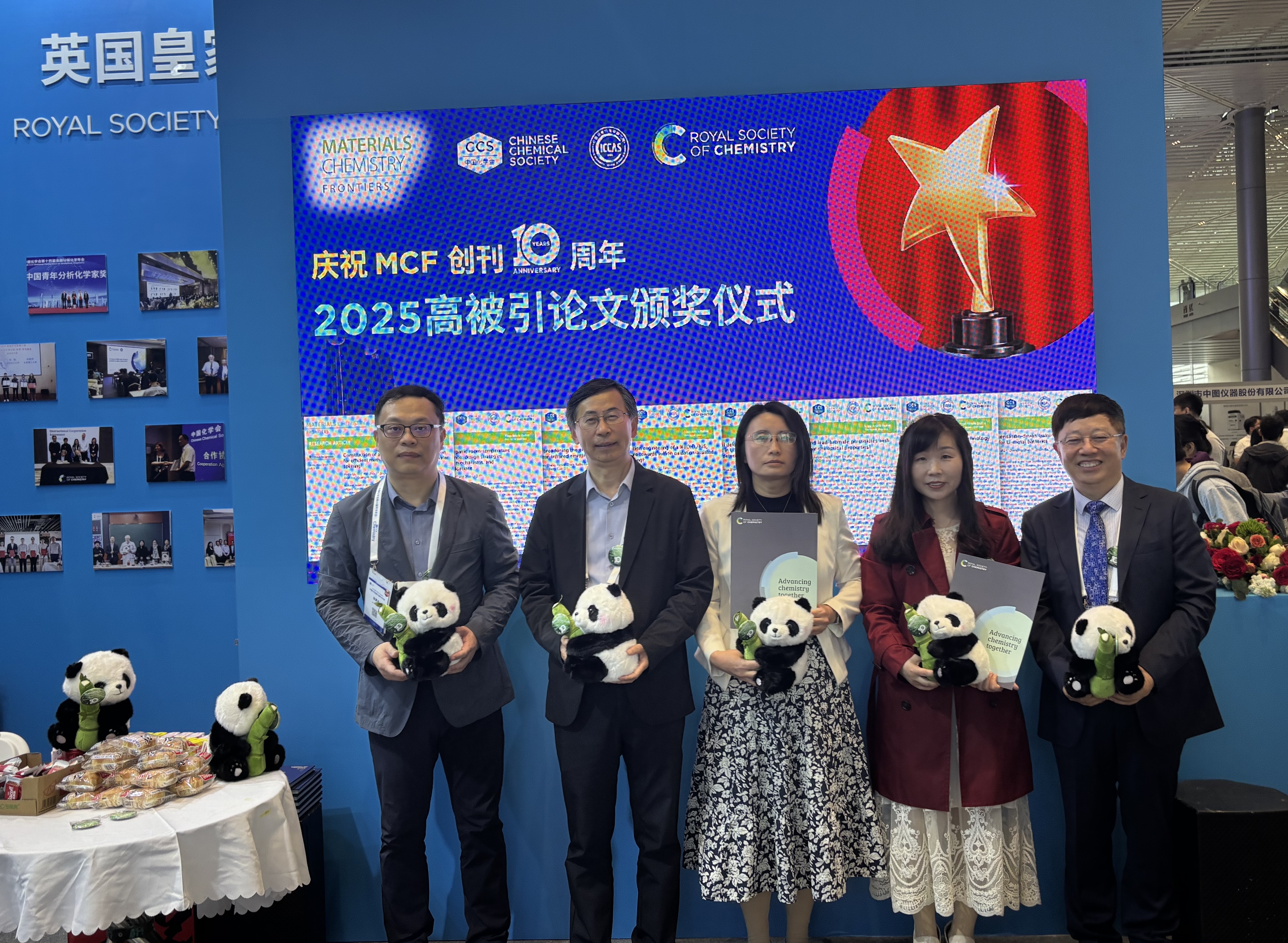 a group of people holding stuffed pandas