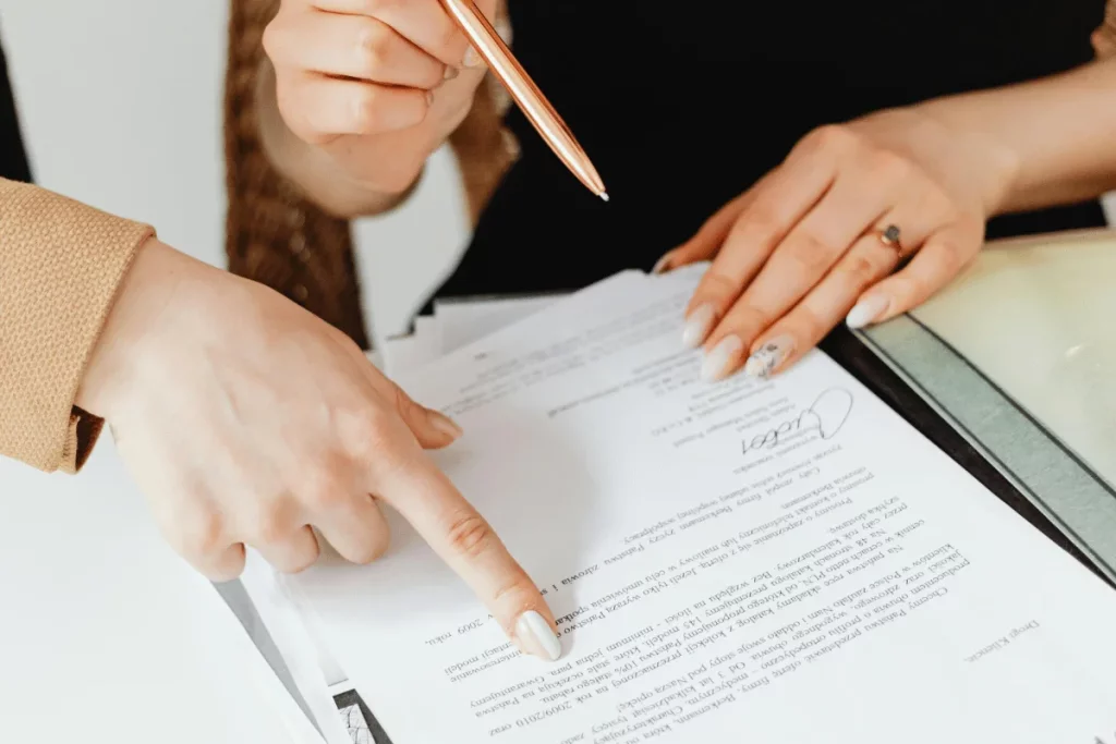 Two people discussing and pointing at a legal document.