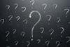 Question marks on a blackboard