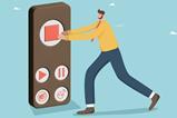 A small man pushes the stop button on a huge remote control