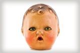 A photo of an old plastic doll's head