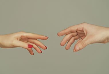 Two people unable to shake hands because they are offering mirror image hands