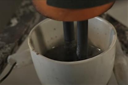 Molten zinc chloride inside a crucible, with two graphite electrodes
