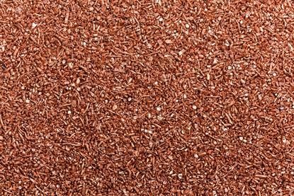A full-frame photograph of small copper granules