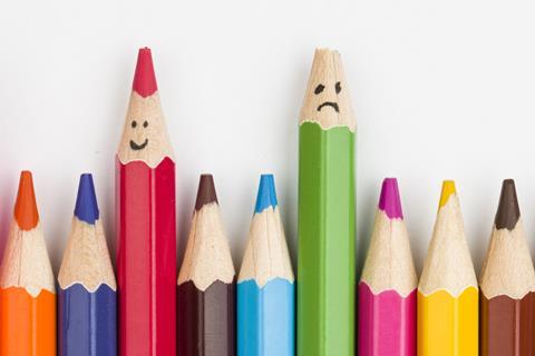 Colouring pencils. One is sharpened and has a smiley face and another has a broken tip and a sad face