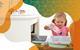 Photo of a young girl putting a plastic bottle into a household bin