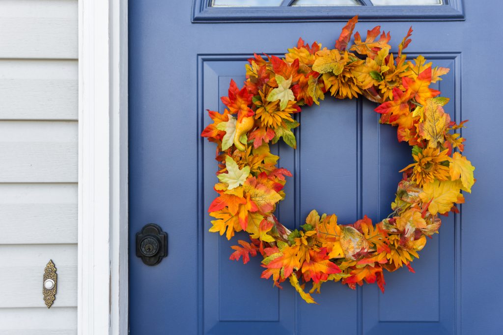 Blue front door with festive autumn wreath
