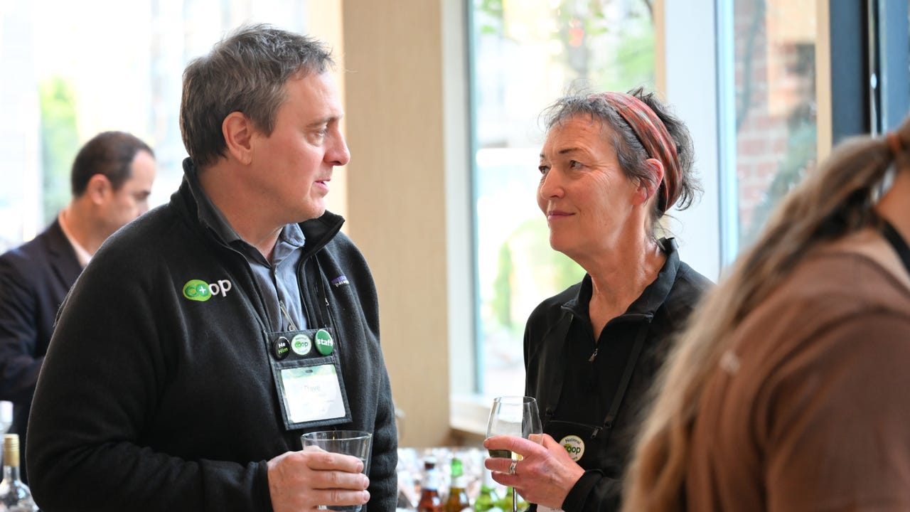 Dave Schermerhorn talks to a woman at a social function. Dave Schermerhorn talks to a woman at a social function.
