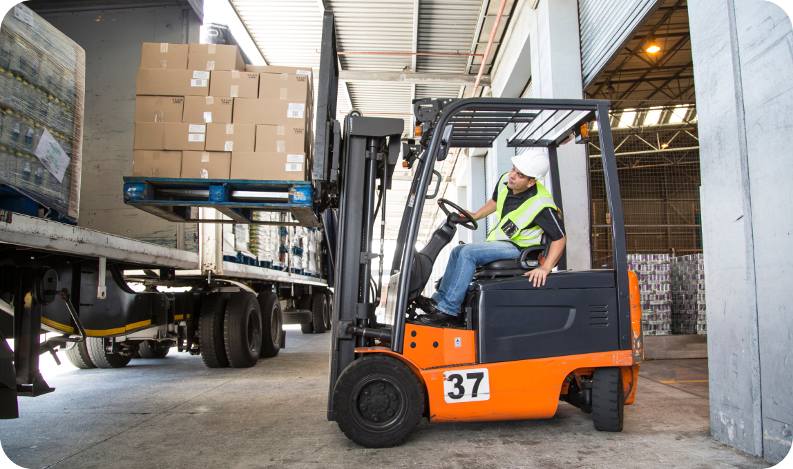 forklift putting boxes on a trailer
