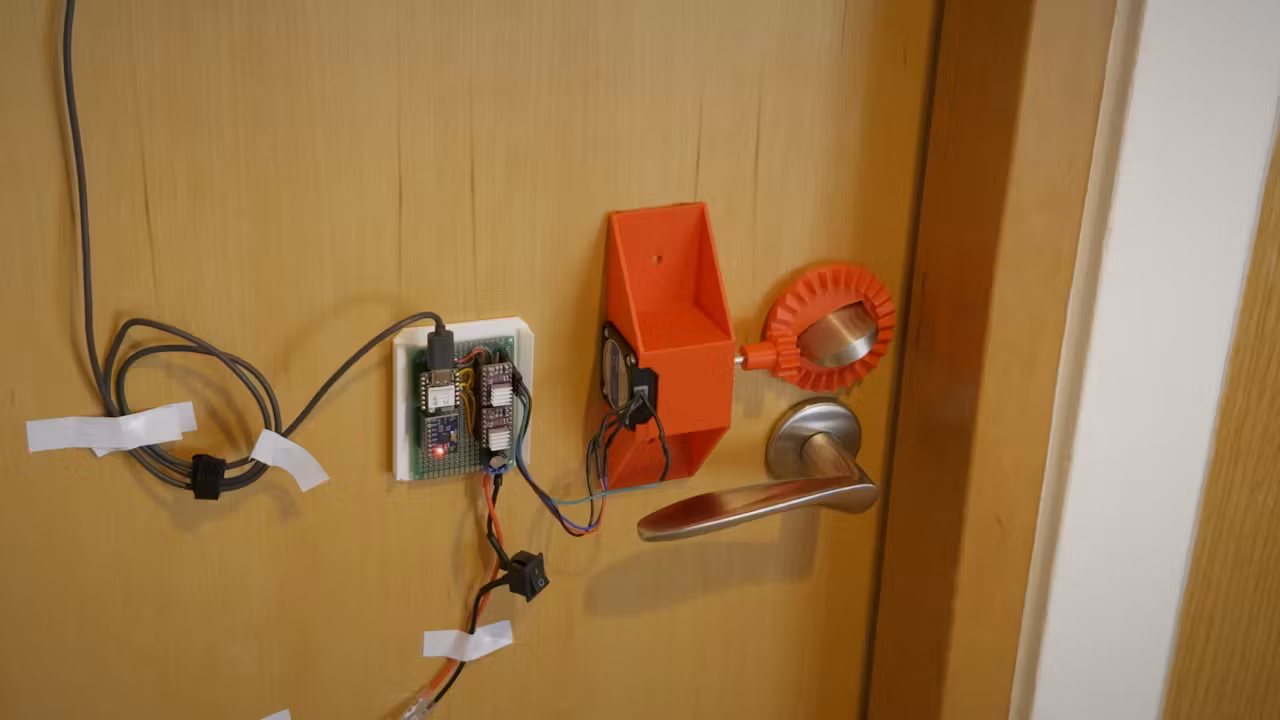 The door-unlocking mechanism, featuring a 3D printed bevel gear and NEMA 17 stepper.