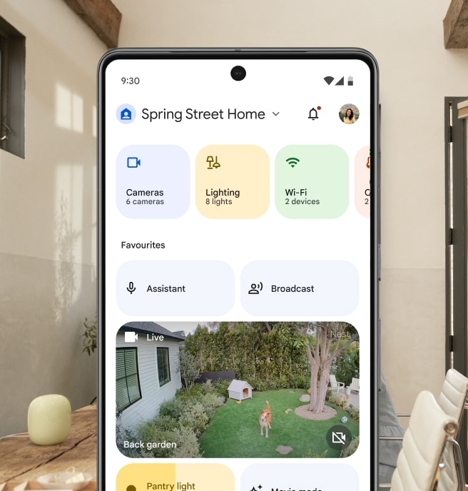 Someone unlocking their home using the Google Home app, including a view of their Pixel phone screen with the Favorites tab and a Nest Camera live view of a dog playing in a backyard.