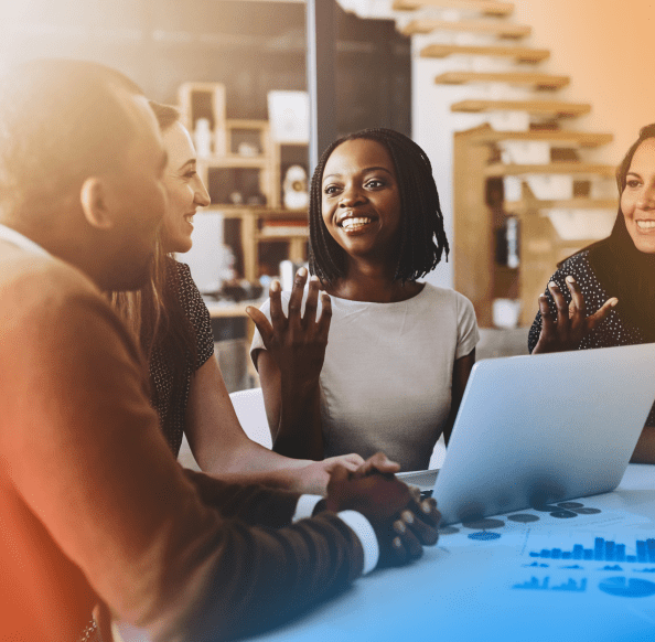 Z Pattern Image (8) Woman speaking to two team members while on her laptop