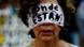 A woman covering her face in protest during a march for the missing Mexican students A woman covering her face in protest during a march for the missing Mexican students