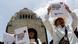 two protesters demand regulation of artificial intelligence by showing Spanish-language posters two protesters demand regulation of artificial intelligence by showing Spanish-language posters