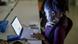 A young woman works focused at her computer. A young woman works focused at her computer.