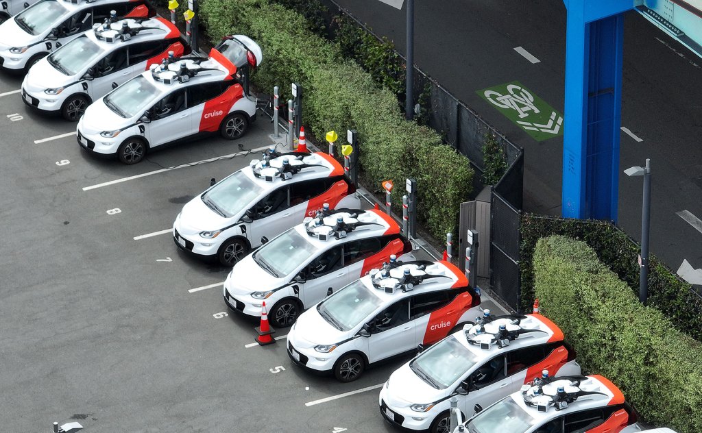 SAN FRANCISCO, CALIFORNIA - JUNE 08: In an aerial view, Chevrolet Cruise autonomous vehicles sit parked in a staging area on June 08, 2023 in San Francisco, California. Autonomous vehicle companies Cruise and Waymo have been testing their vehicles throughout San Francisco and residents are not happy with the problems that the cars are bringing to the city. The cars frequently stop in the middle of roads for no reason, have driven through police crime tape and most recently struck and killed a dog. (Photo by Justin Sullivan/Getty Images)